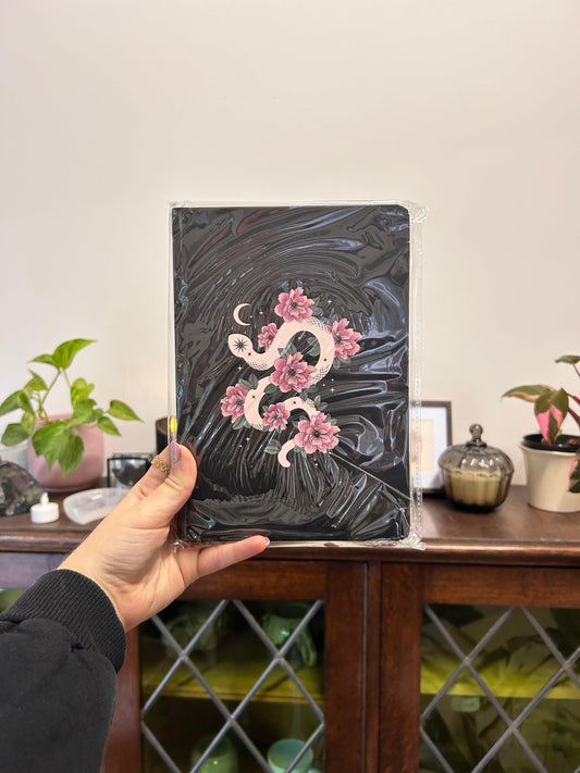 black notebook with snake and flowers
