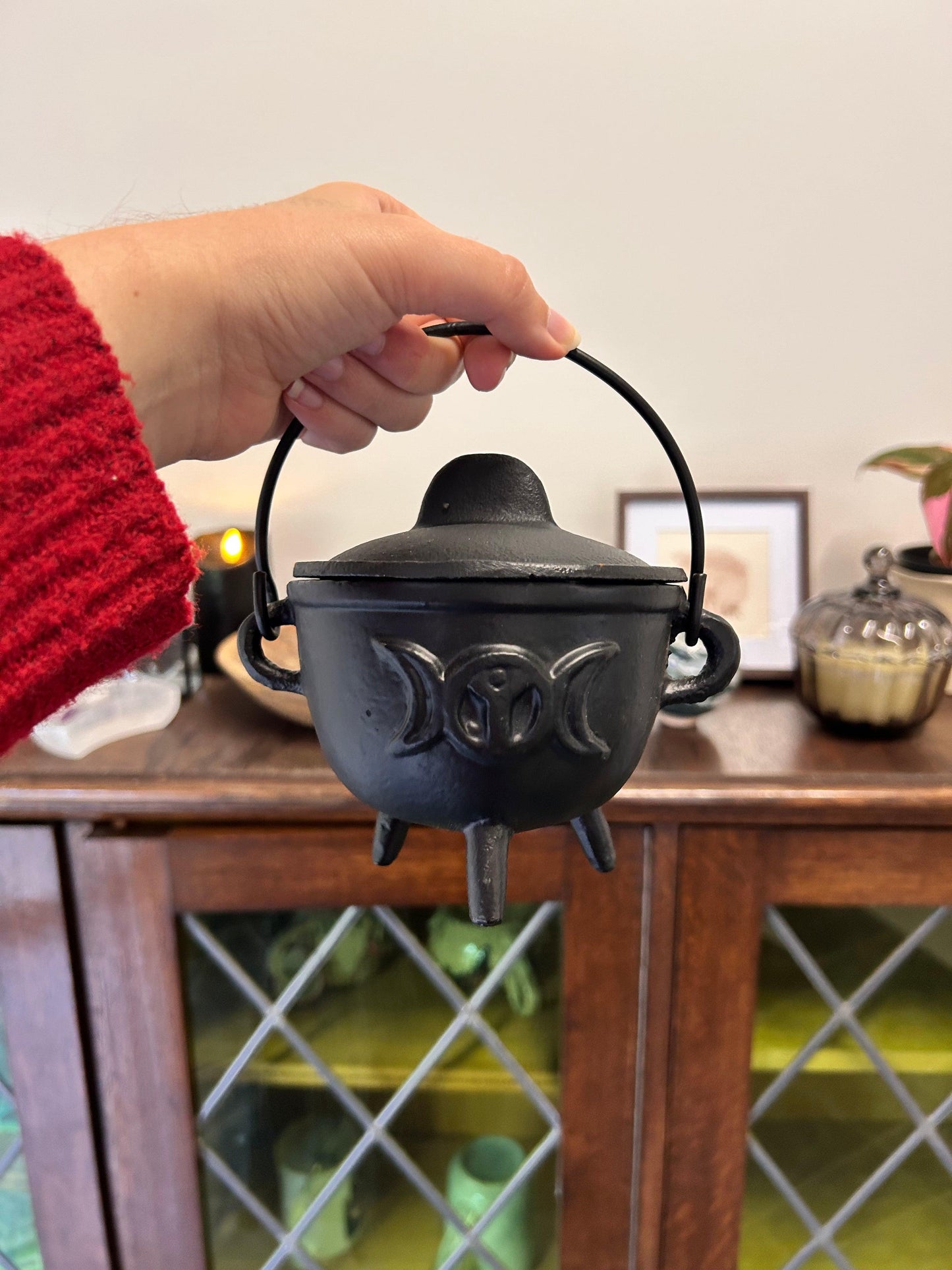 cast iron cauldron with sun and moon